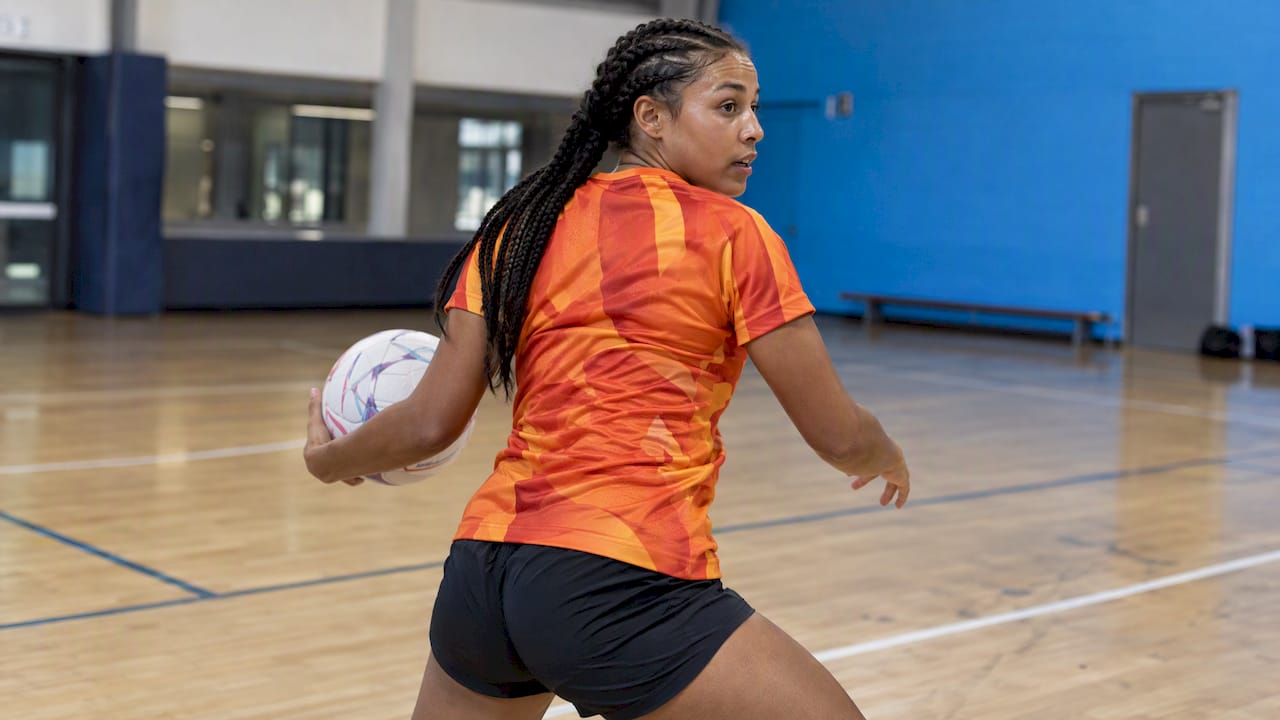 Full-colour netball top flexes during play